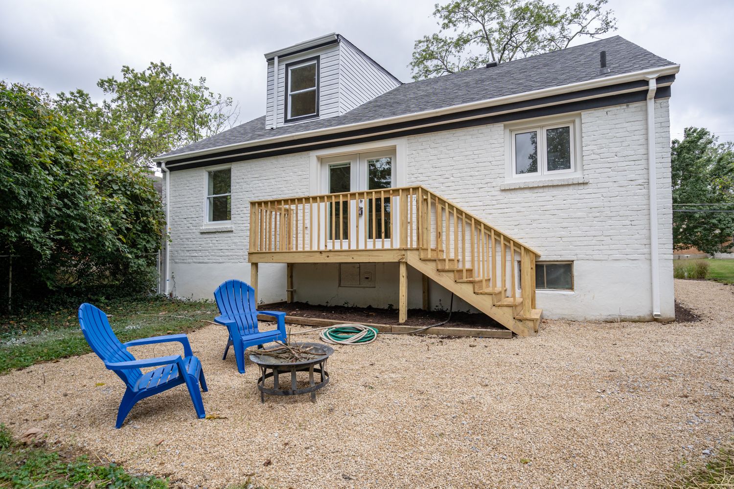 Rear exterior with new wood deck and gravel patio
