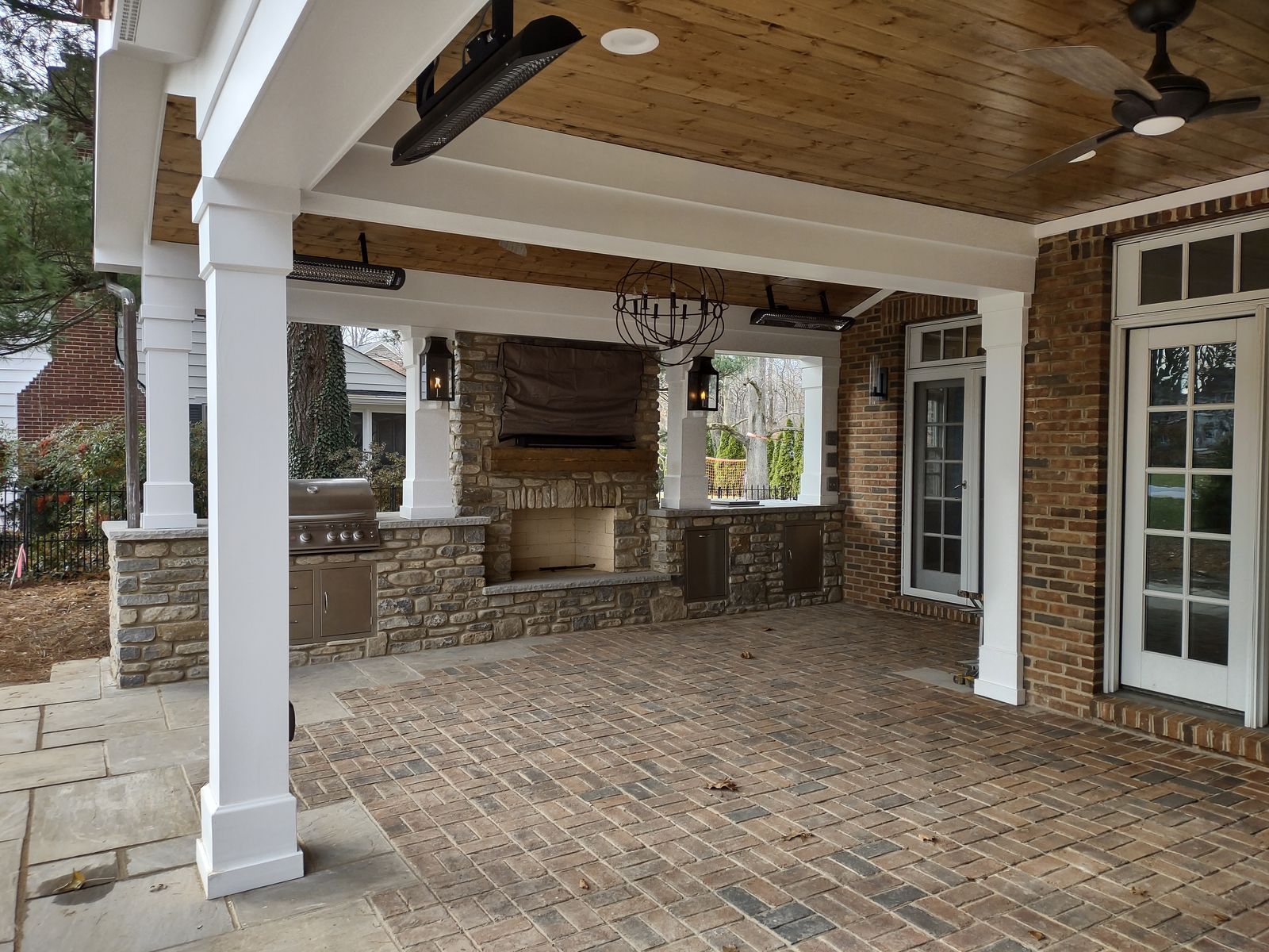 Stone fireplace inside a covered porch