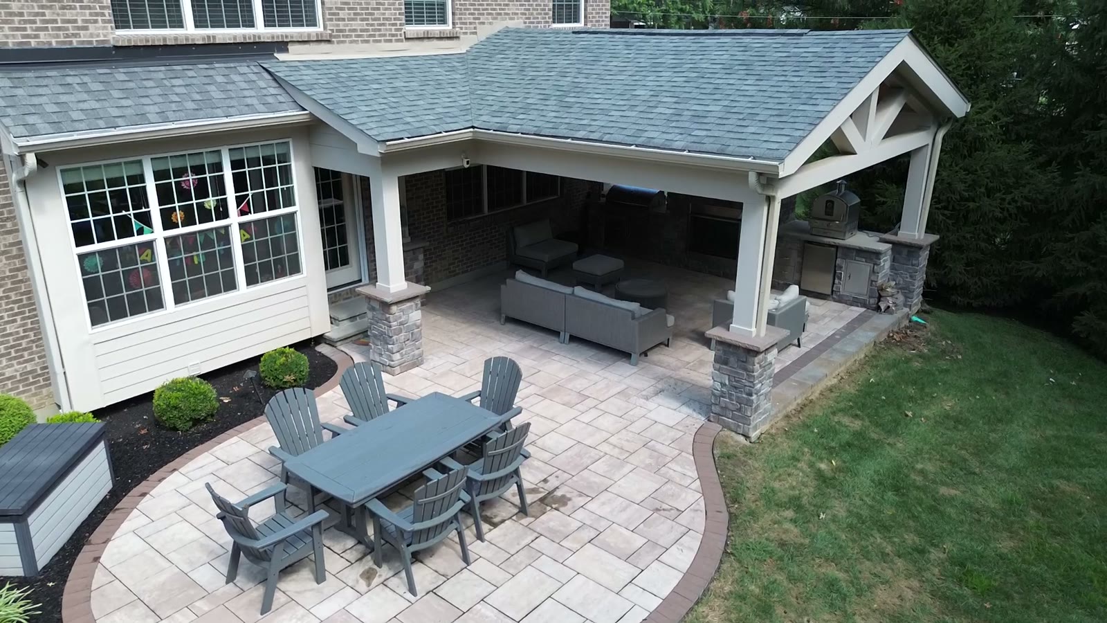 Aerial and ground footage of the covered outdoor kitchen and living room project.