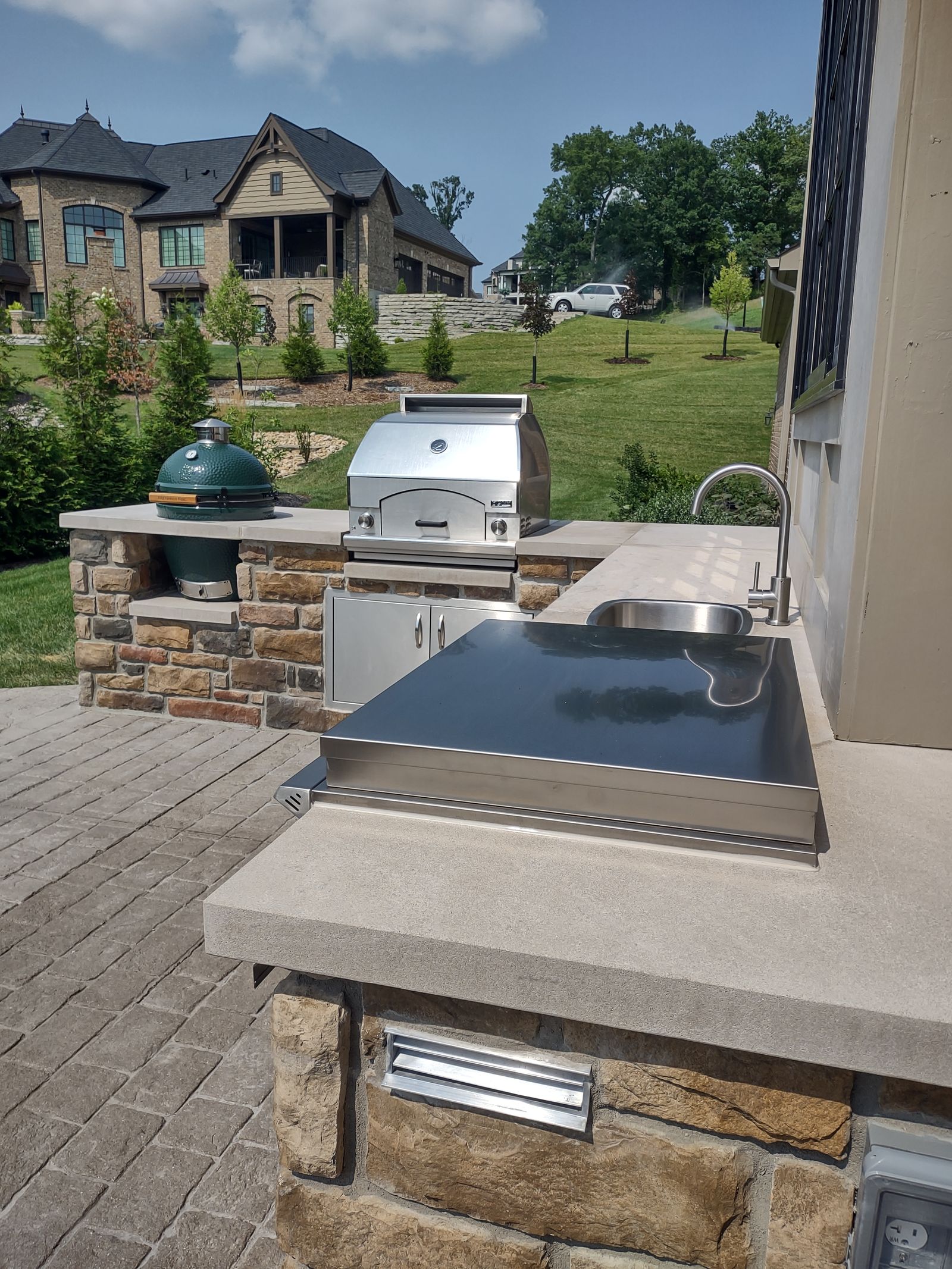 Built-in grill with stone surround and bar seating