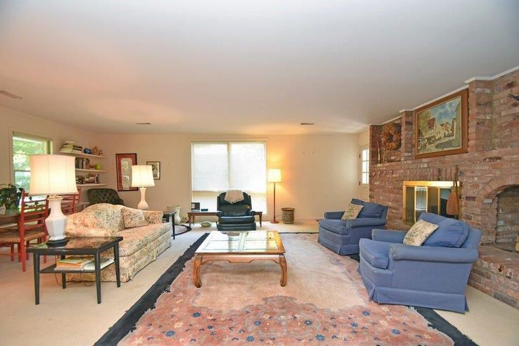 Original living room with brick fireplace before remodel