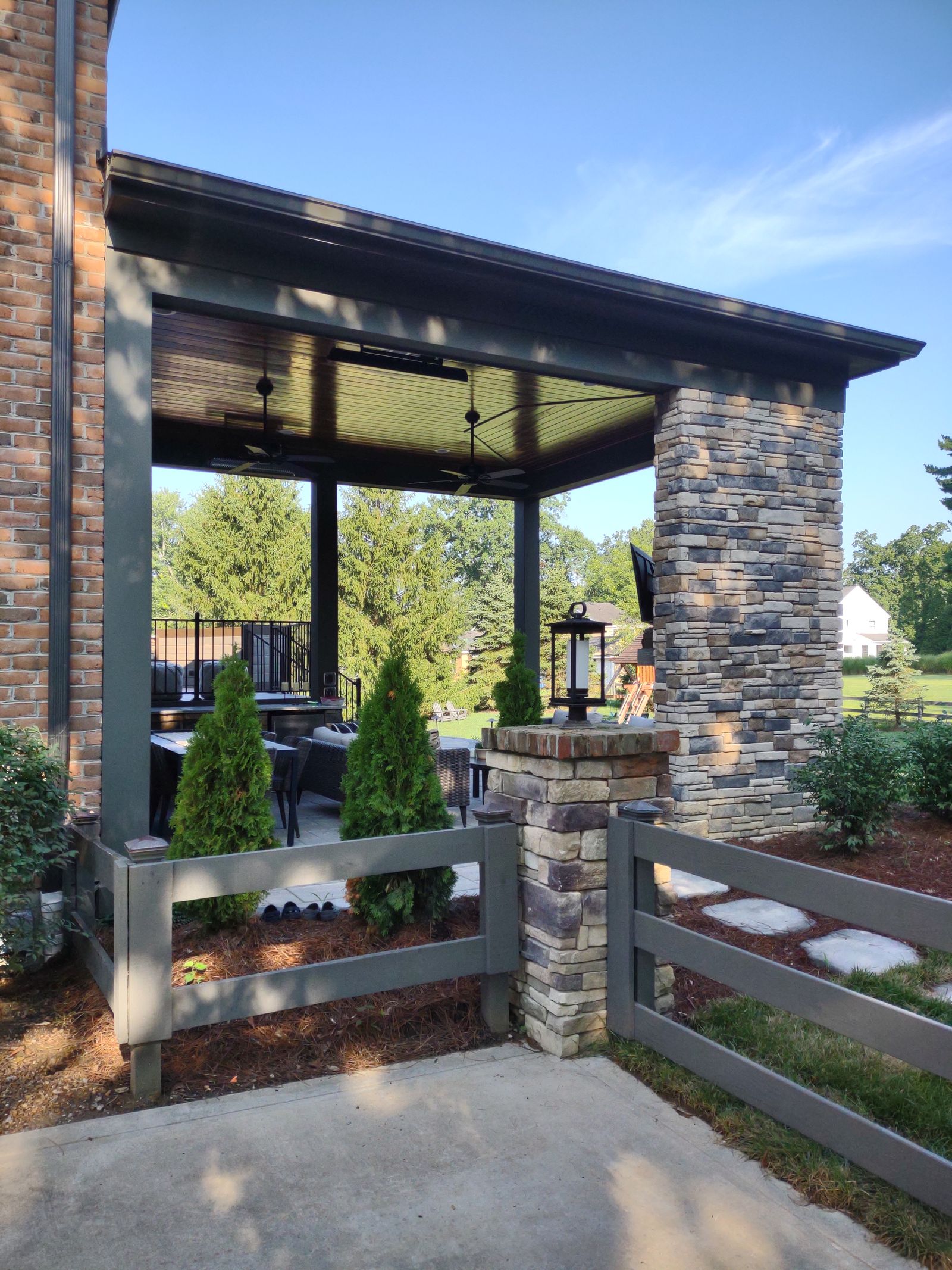 Wide view of a two-story deck and stone fireplace