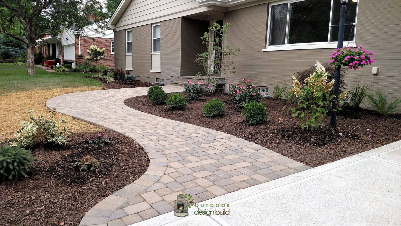 Paver entry walk meeting a new driveway